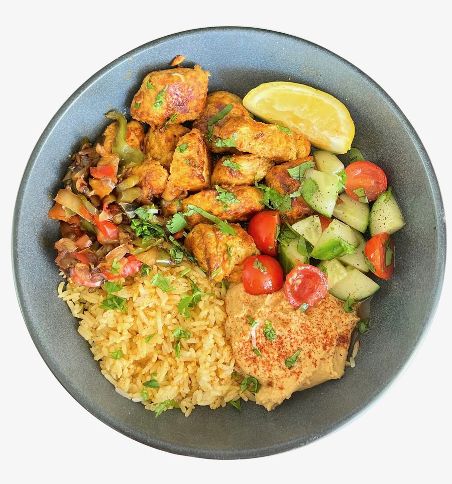 Chicken power rice bowl — spiced chicken, seasoned rice, hummus, and cucumber-tomato salad
